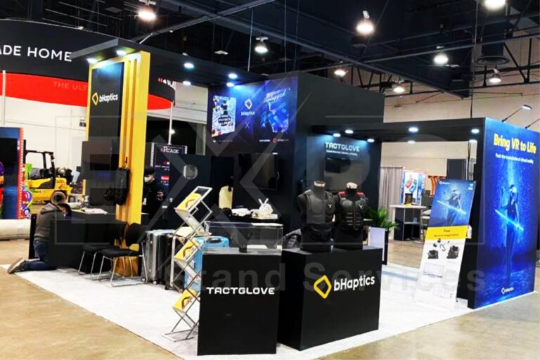 Behaptics trade show booth featuring haptic vests and gloves, with interactive VR demos and branded displays.